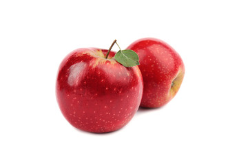 Ripe juicy red apples with leaf on white background