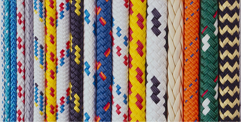 A lineup of colourful assorted yachting ropes - obrazy, fototapety, plakaty