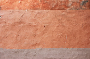 orange wall texture. plaster painted with different shades.