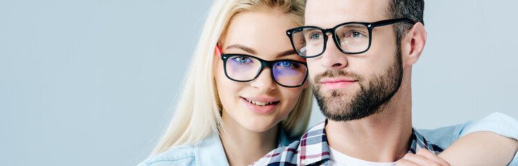 panoramic shot of man and beautiful girl in glasses isolated on grey - obrazy, fototapety, plakaty