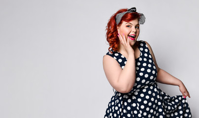 Pin up a female portrait. Beautiful retro fat woman in polka dot dress with red lips and manicure...