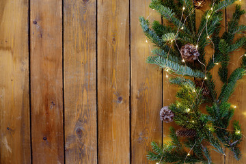 Christmas fir tree with decoration on dark wooden board