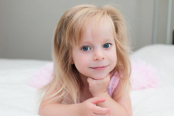 Close up portrait of Cute Blonde Toddler, 3 Years Old Girl, with Big Blue Eyes, in Pink fluffy Dress, Happy Child, The Most Beautiful Girl in the world