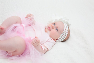 Portrait of 4 Month Old Cute Baby Girl with Big Eyes, Infant ,lying on the white bed, New family concept, The most Beautiful Baby Princesse, Happy Baby Girl