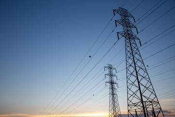 Look up High voltage of power transmission towers. Blue sky.
