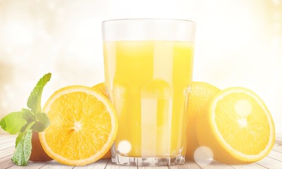 Orange juice and slices of orange on background