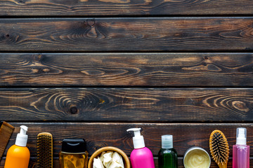 Cosmetic for hair treatment with shampoo, conditioner, styling, oil on wooden background top view mock up