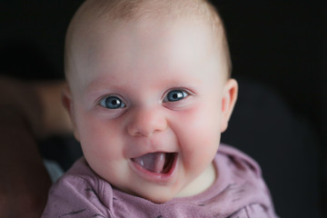 Close up portrait of Cute little girl smile to the Camera, 4 Month Old Baby girl, Funny Face expression 