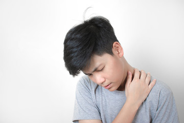 Asian people wear gray t-shirts, feeling neck pain. With the handle on the neck and tilted slightly Health care concept.