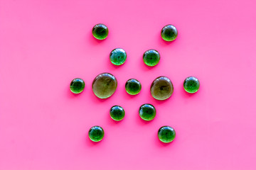 Shiny glass stones for decoration, creativity and craft on pink background top view