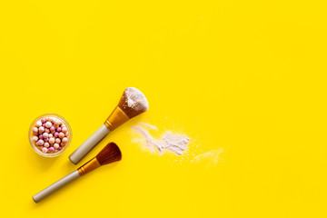 Instruments for make up with brushes, blusher on yellow background top view mock up