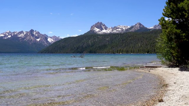 Lapping waves on Redfish Lake in Stanley Idaho in Summer. Sawtooth Mountains in background