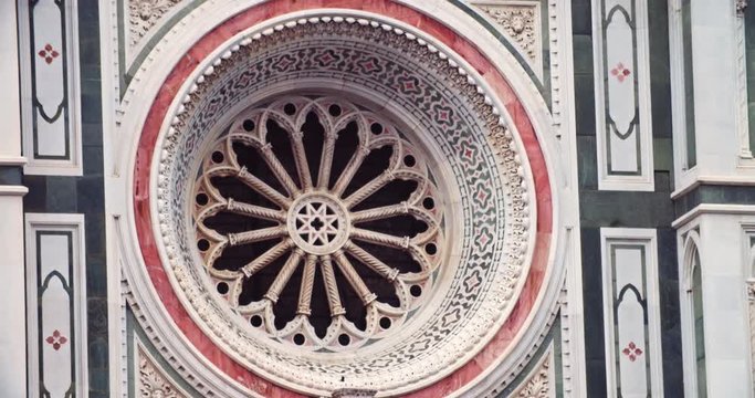 Unique facade of Duomo di Firenze catholic temple. Close-up detail view of majestic Santa Maria del Fiore on sunny day. Famous landmark.