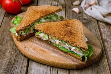 chicken breast and vegetable sandwich on the board