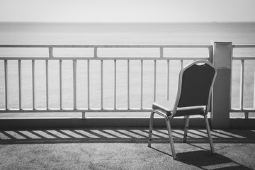 Black and white of Terrace chair on the sky and sea background