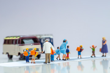 Miniature toys school kids walk on cross road bar code with traffic stopped concept