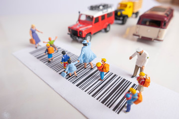 Miniature toys school kids walk on cross road bar code with traffic stopped concept