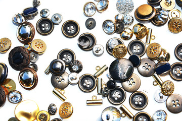 Obraz na płótnie Canvas Metal sewing buttons of different sizes and shapes on an isolated background 