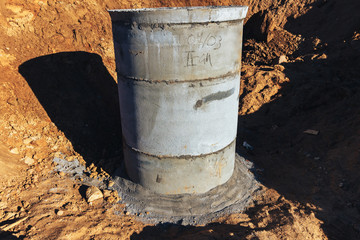 Fototapeta premium Concrete well at the construction site for water pipes