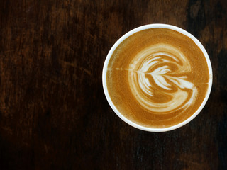 Coffee cup cappuccino latte foam top view on old wooden
