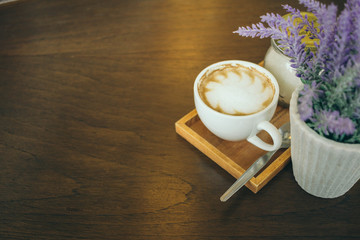 Coffee cup and coffee beans on wooden table  in cafe
