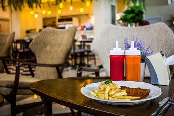 steak with white plate on wooden table