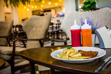 steak with white plate on wooden table