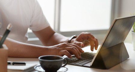Young man typing on keyboard laptop
