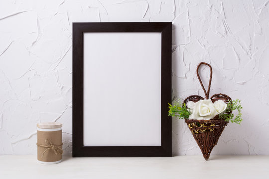 Black brown poster frame mockup with roses in wicker flower pot