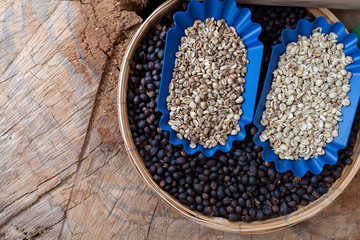 Raw coffee beans with shell and hemispherical on rustic wood background Be prepared to roast and make organic coffee.