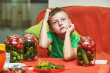 Children cook vegetables for the winter . Home canning . Help parents in the kitchen .