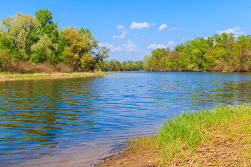 Summer landscape with beautiful river, green trees and blue sky
