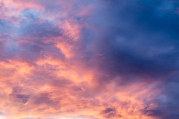 Naklejka na ściany i meble Beautiful sky with multicolored clouds at sunset.
