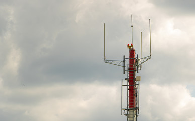 Telecommunication tower on the cloudy sky. Communication technology