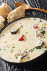 Cream eel soup with vegetables close-up in a bowl. vertical