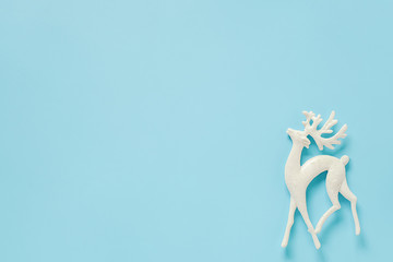 White christmas decoration deer toy on blue background with copy space. Concept Merry christmas or...