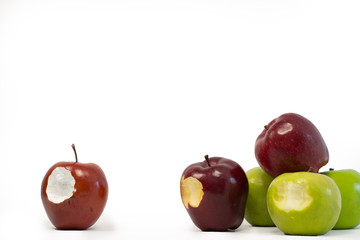 A fake apple singled out as fake by a group of real apples