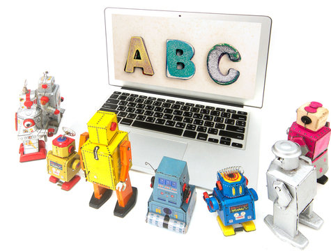 robot toys learing ABC on a laptop computer