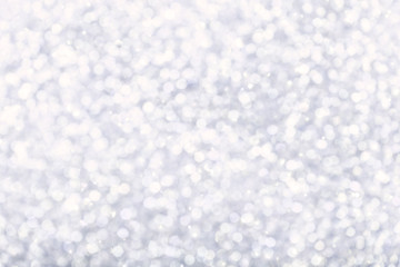 Blurred shiny white background with sparkling lights.