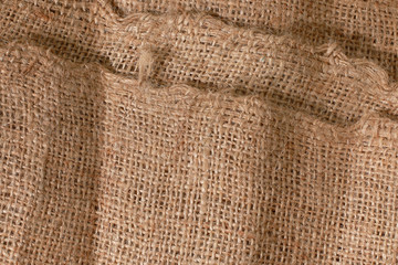 Fototapeta premium This one has a fairly rough texture. This was once a burlap, woven using goat hair with a dark color. In addition, burlap fabric is also made from jute fiber. You can use this photo as a background