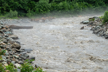 The powerful flow of a mountain river in the spring