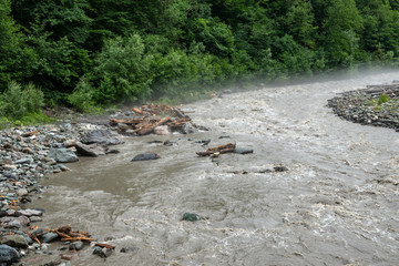 The powerful flow of a mountain river in the spring