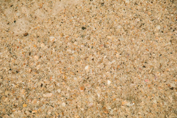 Beautiful golden sand with sea water wave background on sunny day