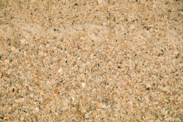 Beautiful golden sand with sea water wave background on sunny day