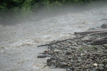 The powerful flow of a mountain river in the spring