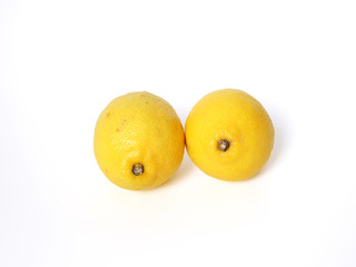 Two fresh sour lemon isolated white background