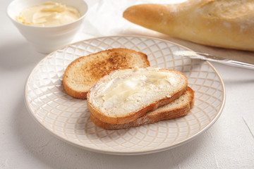 Tasty bread with butter for breakfast on plate