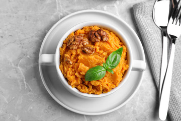 Tasty sweet potato puree served on grey marble table, top view
