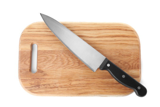 Wooden cutting board with chef's knife isolated on white, top view