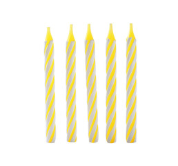 Yellow striped birthday candles isolated on white